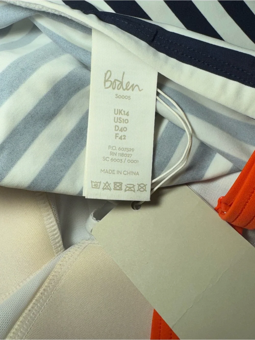 Boden white and navy striped swim suit tank top with orange straps and tie side🗻